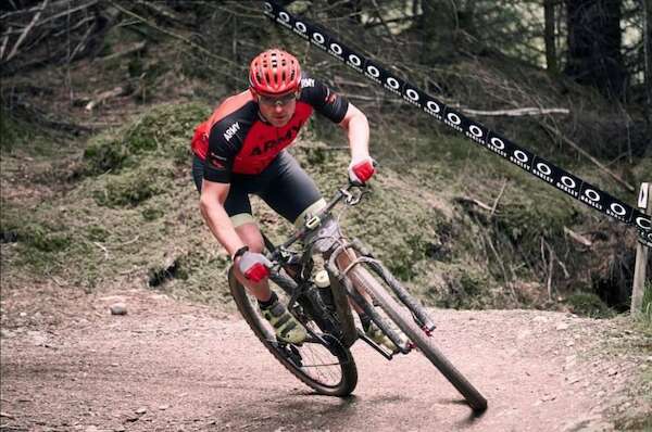 man racing on a mountain bike